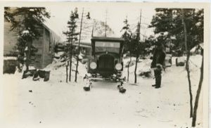 Image: Snowmobile hauling wood to camp
